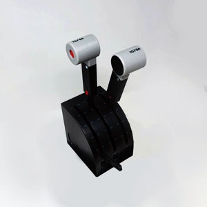 May include: Black throttle control panel with two grey TO/GA levers. The levers have red accents and are labelled "TO/GA".