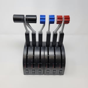 May include: A set of five black throttle controls with red and blue knobs. The controls are mounted on a black base with a silver trim. Each control has a small lever and a series of markings.