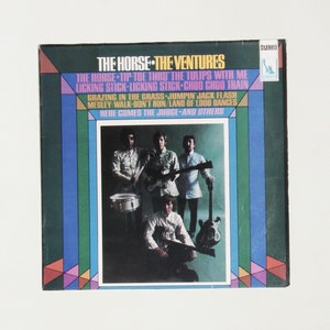 May include: A vintage vinyl record album cover featuring a band called "The Ventures" with a colorful geometric design and a photo of the band members playing instruments. The album title is "The Horse" and includes song titles like "Tip-Toe Thru The Tulips With Me" and "Licking Stick-Licking Stick Choo Choo Train".