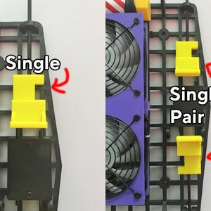 May include: Two black plastic fan mounts with yellow plastic clips labeled "Single" and "Single Pair".