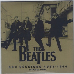 May include: Album cover featuring The Beatles in a sepia-toned image, with the band members walking on a city street. The band's name is prominently displayed in large, dark blue letters, with the text "BBC Sessions 1963-1964" below. The album is in spectral stereo.