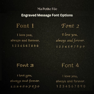 May include: A black display card titled Ma Petite F&eacute;e Engraved Message Font Options, showcasing four distinct gold-colored font styles. Each section displays the text I love you, always and forever, followed by the numbers 1 through 0.