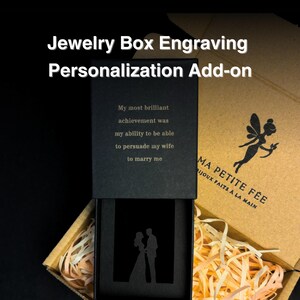 May include: A black jewelry box with a sliding lid featuring the engraved text My most brilliant achievement was my ability to be able to persuade my wife to marry me and a silhouette of a couple. The box sits in a brown cardboard gift box.