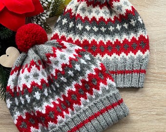 Bright winter hat with red ornament knitted pattern