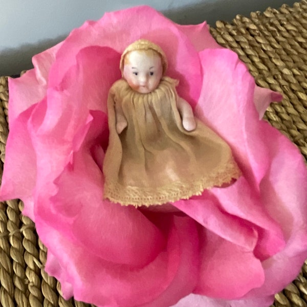 Bisque Thumbelina Baby-Doll, 1800s, collectible, hand made dress and hat, articulated, baby doll legs and arms. 1 3/4 “ HI,  MUSEUM quality