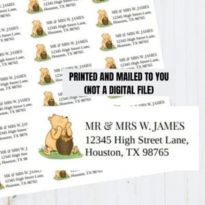 May include: A sheet of 24 Winnie the Pooh return address labels. Each label features a cartoon illustration of Winnie the Pooh holding a pot of honey. The text on the label reads "MR & MRS W. JAMES 12345 High Street Lane, Houston, TX 98765". The text "PRINTED AND MAILED TO YOU (NOT A DIGITAL FILE)" is printed on the sheet of labels.