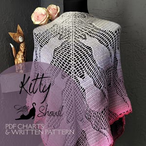 May include: A crochet shawl with a delicate pattern of stylised cats. The shawl is made in a gradient of pink, purple, and grey yarn. The text "Kitty Shawl" is visible in the image. The text "PDF Charts & Written Pattern" is also visible in the image.