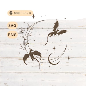May include: A brown digital illustration featuring two dragons, a crescent moon, stars, and floral elements. The image includes the text "SVG" and "PNG", and a sale badge with the text "Sale! 1+1=3". The design is set against a white wood background.