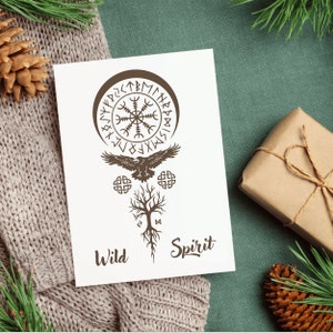 May include: A white card with a brown illustration of a raven flying above a tree with roots, a circle with runes, and the words "Wild Spirit".