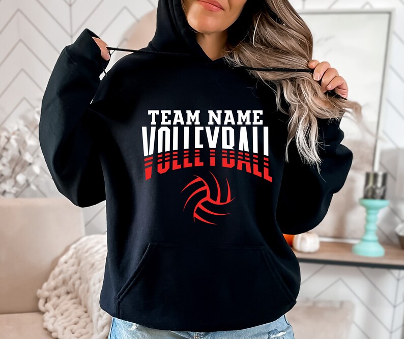 May include: Black hooded sweatshirt with a white and red graphic print of a volleyball and the text "TEAM NAME VOLLEYBALL".