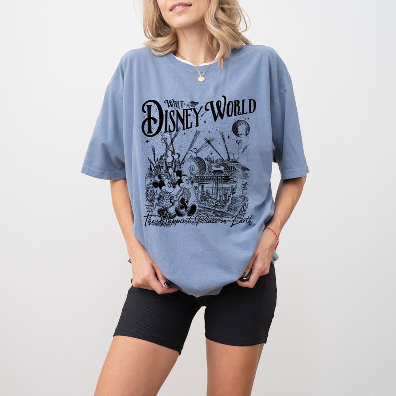 a woman wearing a disney world t - shirt