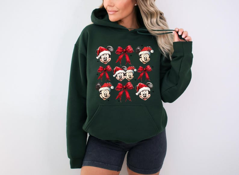 a woman wearing a mickey mouse christmas sweatshirt