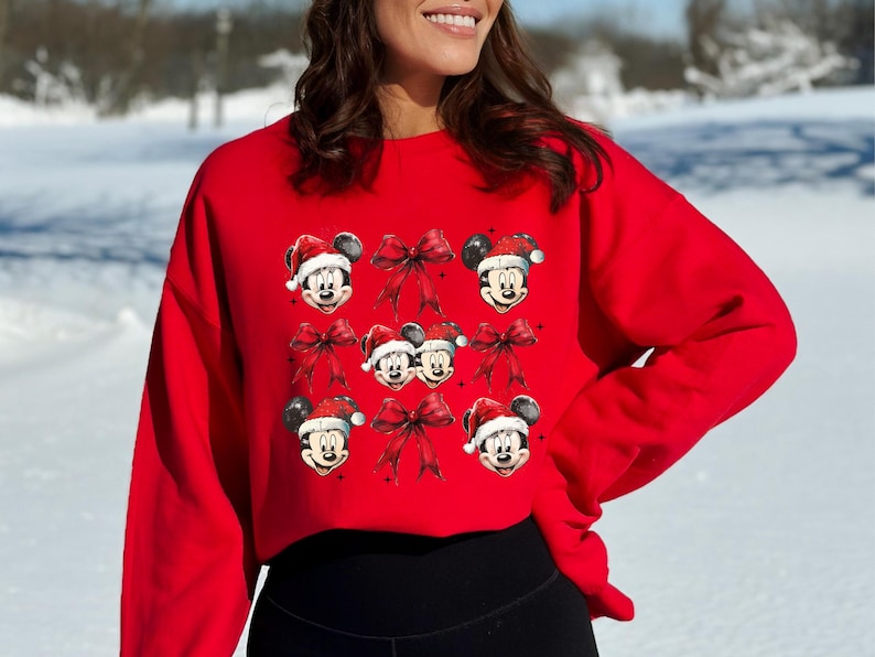 a woman wearing a mickey mouse christmas sweater