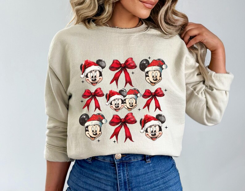 a woman wearing a sweater with mickey mouses on it