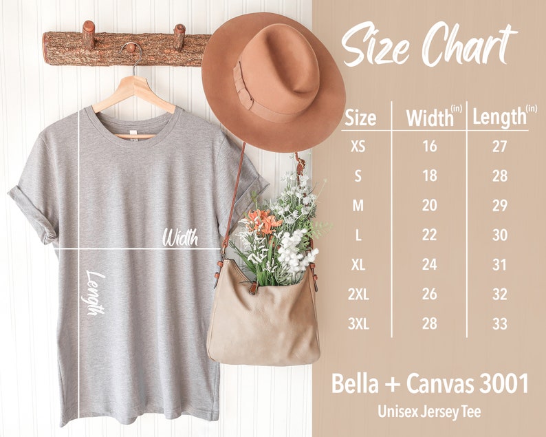 May include: Size chart for a unisex jersey tee, showing measurements in inches for width and length. The chart includes sizes XS through 3XL. The image also shows a gray t-shirt hanging on a wooden hanger, a brown hat, and a brown bag.