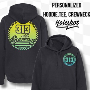 Puede incluir: Sudadera con capucha negra con un c&iacute;rculo degradado verde, amarillo y azul en la parte delantera. El c&iacute;rculo tiene el n&uacute;mero "313" y la palabra "Bentley" en su interior. La parte posterior de la sudadera tiene una versi&oacute;n m&aacute;s grande del c&iacute;rculo con el mismo dise&ntilde;o.