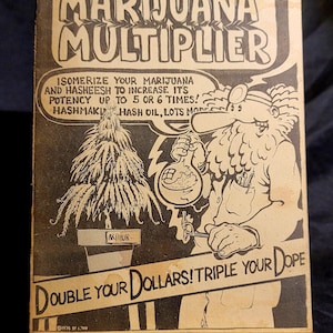 May include: A vintage 1974 Dr. Atomic's Marijuana Multiplier comic book with black and white cover art featuring a bearded scientist, a plant, and text. A wooden ruler shows the book is approximately 5 inches wide at the base of the cover.