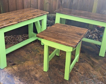 Two Vibrant Green Benches with a Dark Oak Finish and a Small Table Outdoors Garden Exterior
