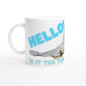 May include: White ceramic mug with a blue graphic of a person lying down with the text "HELLO! IS IT TEA YOU'RE LOOKING FOR?"