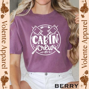a woman with long hair wearing a purple shirt