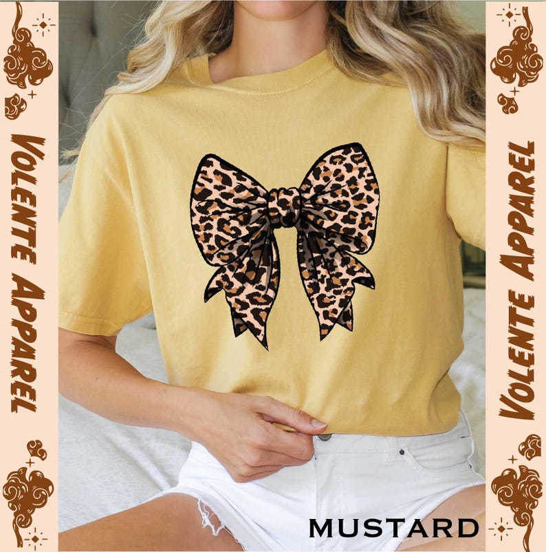 a woman wearing a yellow shirt with a leopard print bow