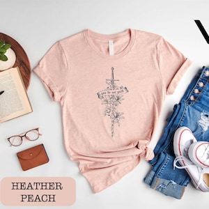 a women's t - shirt with a cross and flowers on it