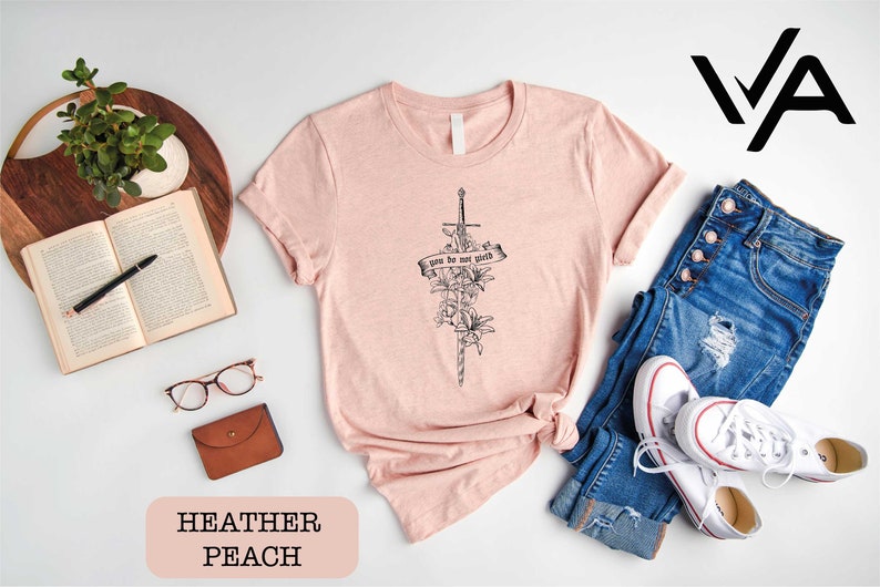 a women's t - shirt with a cross and flowers on it