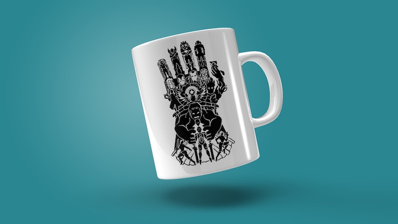 May include: White ceramic mug with a black silhouette of a hand with multiple superhero figures, including Hulk, Iron Man, and Thor.