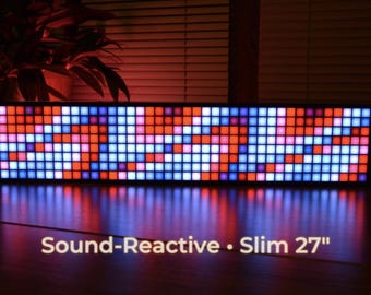 May include: A sound-reactive, slim 27-inch LED display with a grid of colorful squares. The display shows a pattern of red, orange, blue, and white lights. The text "Sound-Reactive • Slim 27" is at the bottom.