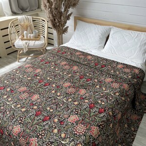 May include: A black and green floral patterned bedspread with red and yellow accents. The bedspread is made of cotton and is perfect for adding a touch of elegance to any bedroom.