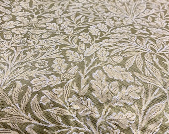May include: Close-up of a green fabric with a white floral pattern. The fabric has a textured, woven look.