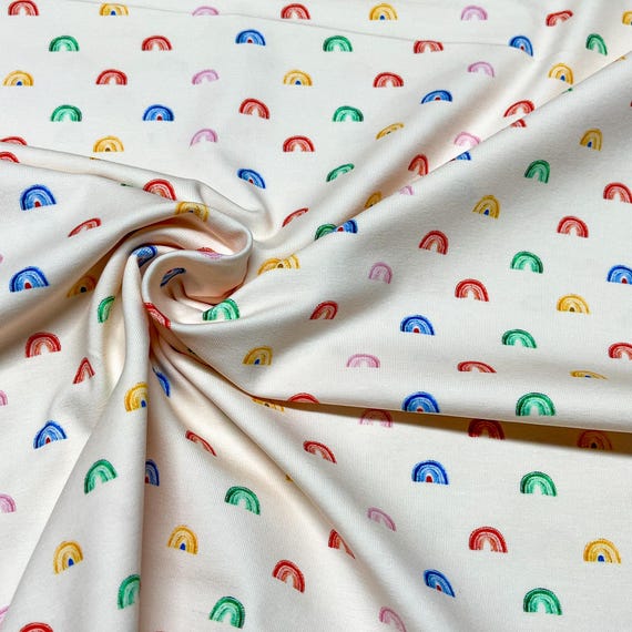Jersey Stoff Regenbogen beige Babykleidung klein gemustert