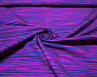 May include: Purple and blue striped fabric with a textured, woven look. The fabric is folded and draped, showing the texture and pattern.
