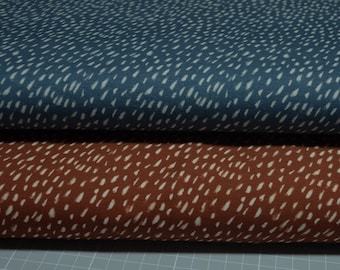 May include: Two fabric swatches with a white dash pattern on a blue and brown background.