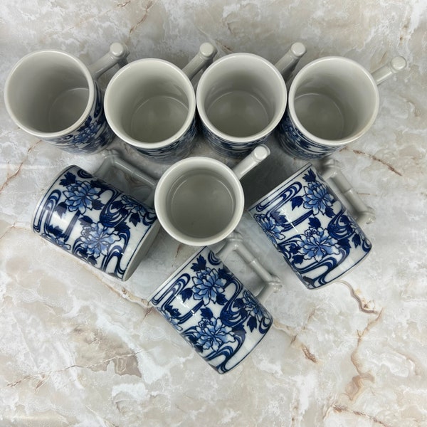 Set of 8 Vandor coffee mugs tea cups designed by Nancy Getz. Blue and white floral with bamboo inspired handles.