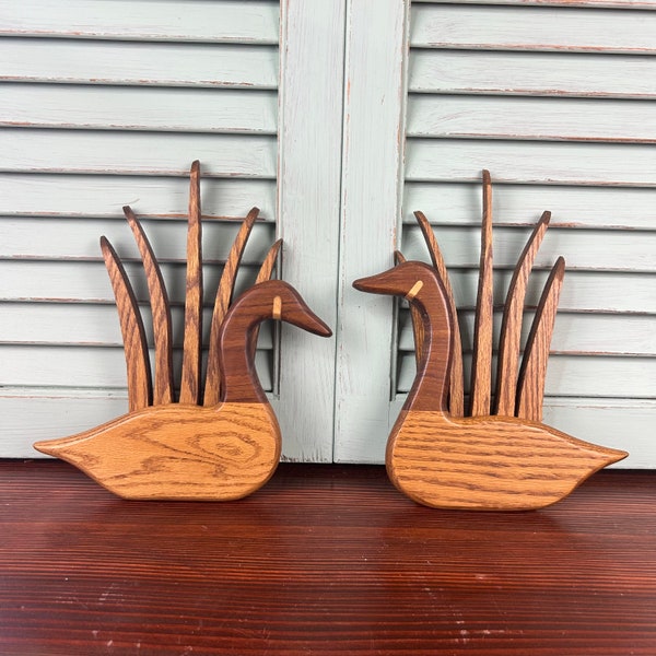 Pair of hand made wooden geese or ducks with cattails in background. 1980’s two tone wood design. Great for your cabin or hunting lodge.