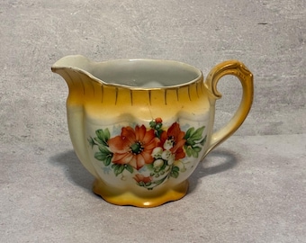Vintage Austria Ceramic Cream Pitcher, Creamer. Orange Poppies & Lily of the Valley. Yellow Gold Background.