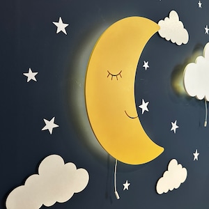 May include: A yellow crescent moon wall light with a smiling face and closed eyes, surrounded by white clouds and stars on a dark blue background.