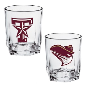 May include: Two clear, faceted lowball glasses. One glass features a maroon "T" with a star, the other a maroon and gold graphic. Both glasses are empty and ready for use.