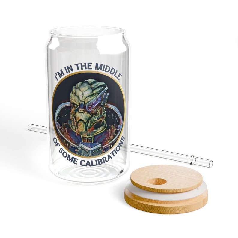 A 16oz clear glass with a stylized image of Garrus from Mass Effect, framed in a circle with the quote “I’m in the middle of some calibrations” in bold, sci-fi inspired font.