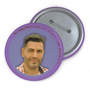May include: Purple button with a man's face and the text "My happiness level is '10 or 1', but mostly a 1."