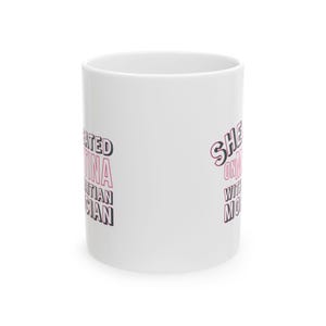 White ceramic mug with bold pink and black text reading “She cheated on Martina with a Haitian mortician,” referencing a Real Housewives of Miami quote.
