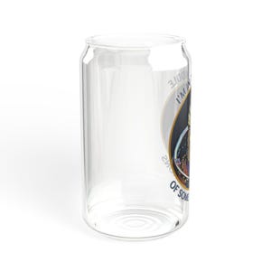 A 16oz clear glass with a stylized image of Garrus from Mass Effect, framed in a circle with the quote “I’m in the middle of some calibrations” in bold, sci-fi inspired font.