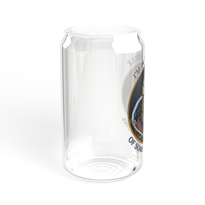 A 16oz clear glass with a stylized image of Garrus from Mass Effect, framed in a circle with the quote “I’m in the middle of some calibrations” in bold, sci-fi inspired font.