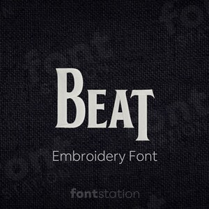 May include: White embroidered text on a dark fabric background that reads "BEAT Embroidery Font".