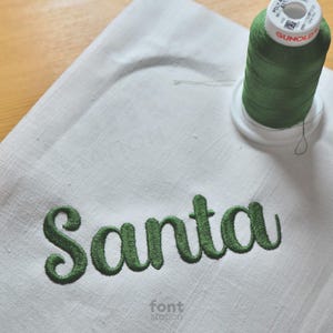 Image showing a word embroidered on textile using the Santa Claus embroidery font created by FontStation
