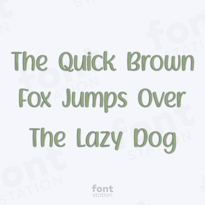 May include: Text-based graphic with the phrase "The Quick Brown Fox Jumps Over The Lazy Dog" in a green, handwritten-style font. The words are centered on a white background. The "font station" logo is at the bottom.