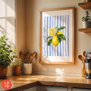 May include: A framed art print featuring a watercolor illustration of lemons with green leaves against a blue and white striped background. The artwork is displayed in a light wood frame, adding a touch of rustic charm to the kitchen setting.