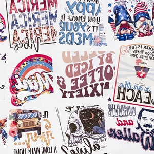 May include: A collection of assorted heat transfer designs featuring various graphics including a rainbow with the word Mama, patriotic gnomes, a skull, a school bus, a beach cocktail, a butterfly, and text-based slogans on white backgrounds.