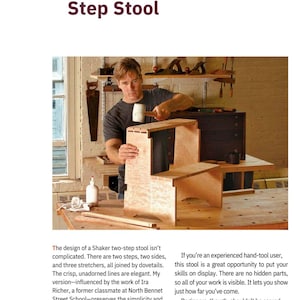 May include: A light-coloured wooden step stool with two steps and a rectangular top is being assembled. A person is using a mallet to secure the pieces. The stool is made of unfinished wood and is in a workshop setting.